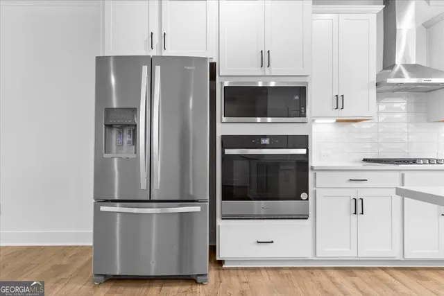 a kitchen with stainless steel appliances sink refrigerator and microwave