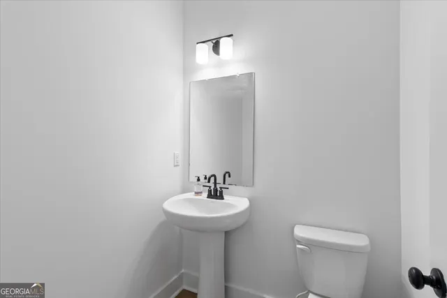 an empty room with closet and windows