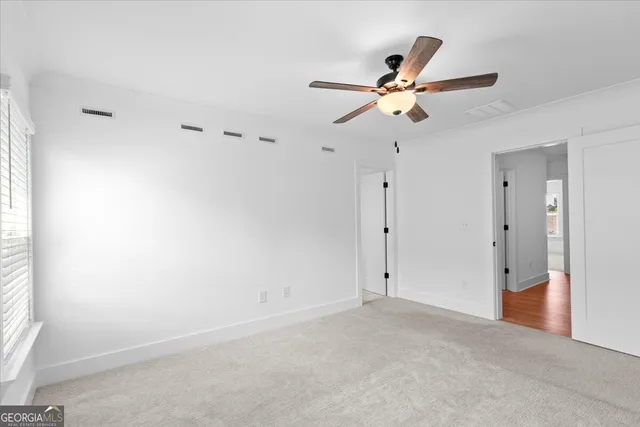 a spacious bathroom with a granite countertop sink mirror and shower