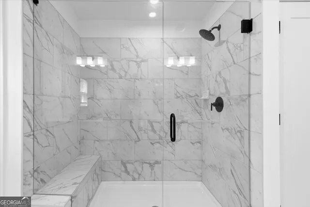 a spacious bathroom with a shower sink and mirror