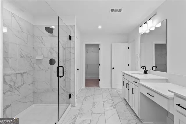 a bathroom with a sink vanity and a mirror