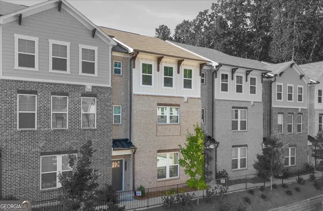 a front view of a building with a yard