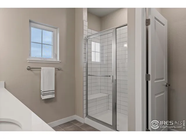 a bedroom with a bed and a large mirror