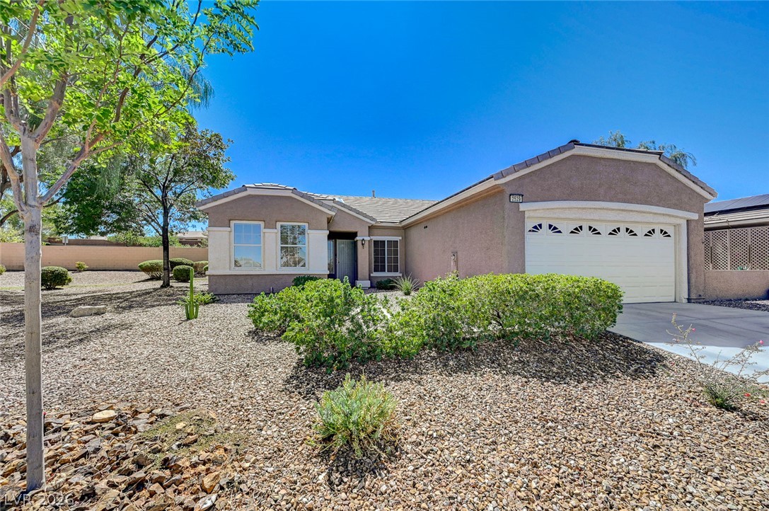 2529 Springville Way Henderson, NV 89052 - Photo 2 of 70 Desert landscaping and a tiled roof complement this single-story home with an attached garage.