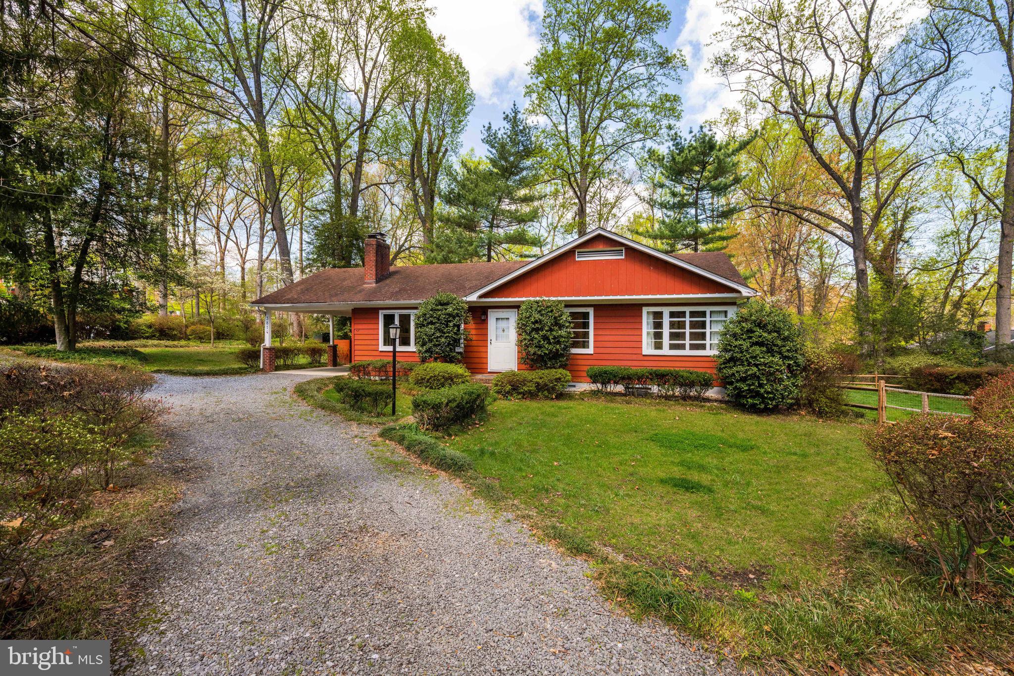 a front view of a house with yard and green space