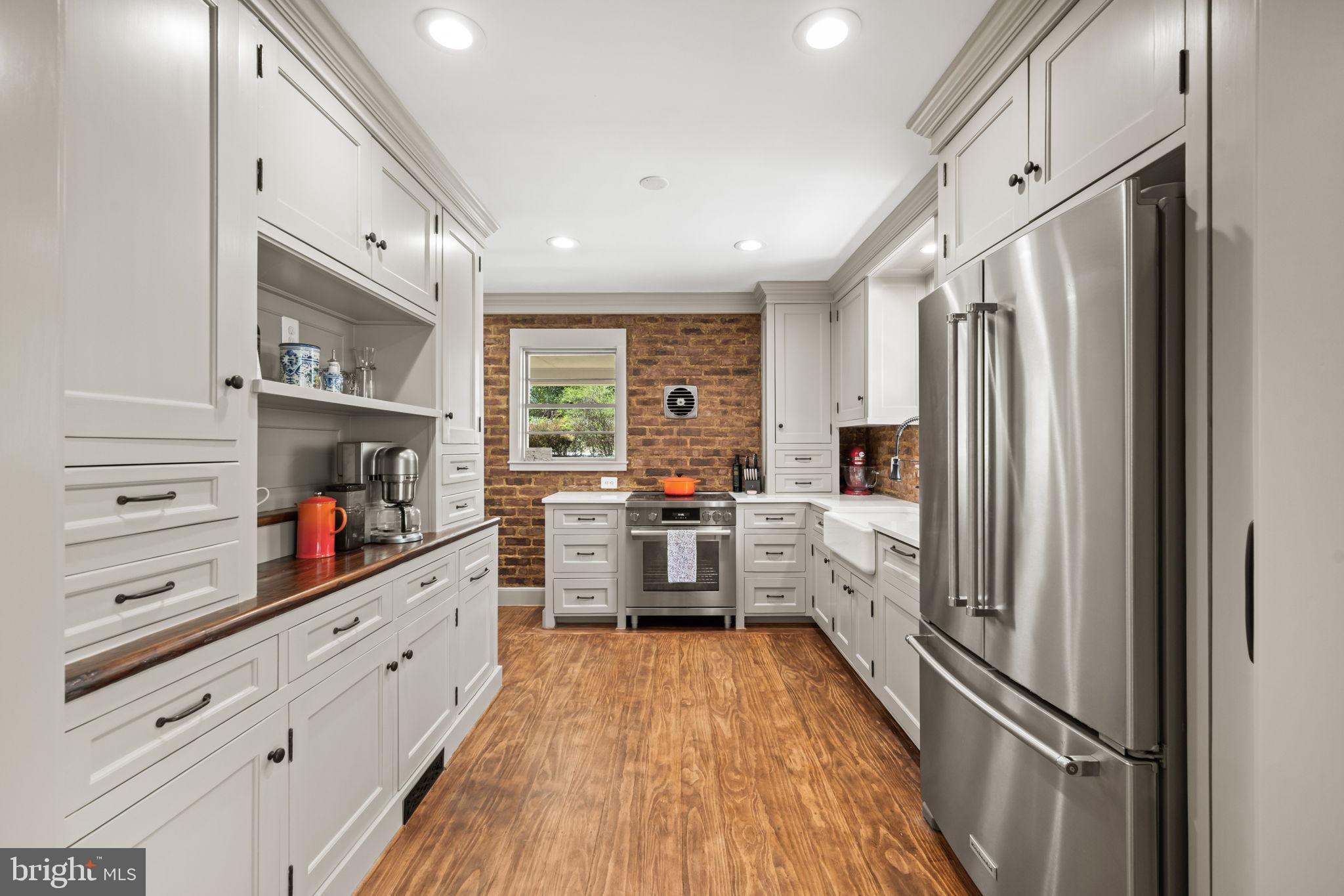3814 Hillcrest Lane Annandale, VA 22003 - Photo 11 of 48 a kitchen with stainless steel appliances a refrigerator sink and white cabinets
