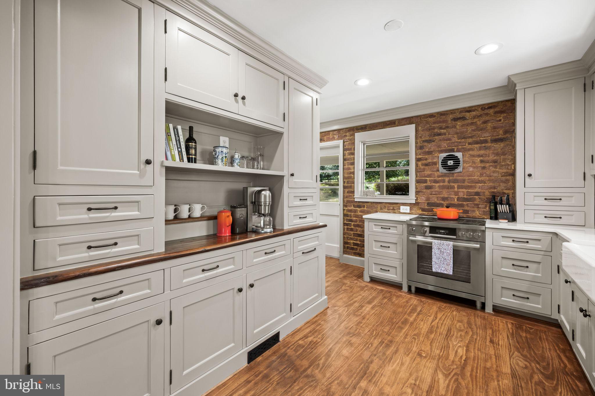 3814 Hillcrest Lane Annandale, VA 22003 - Photo 13 of 48 a kitchen with stainless steel appliances white cabinets and wooden floors