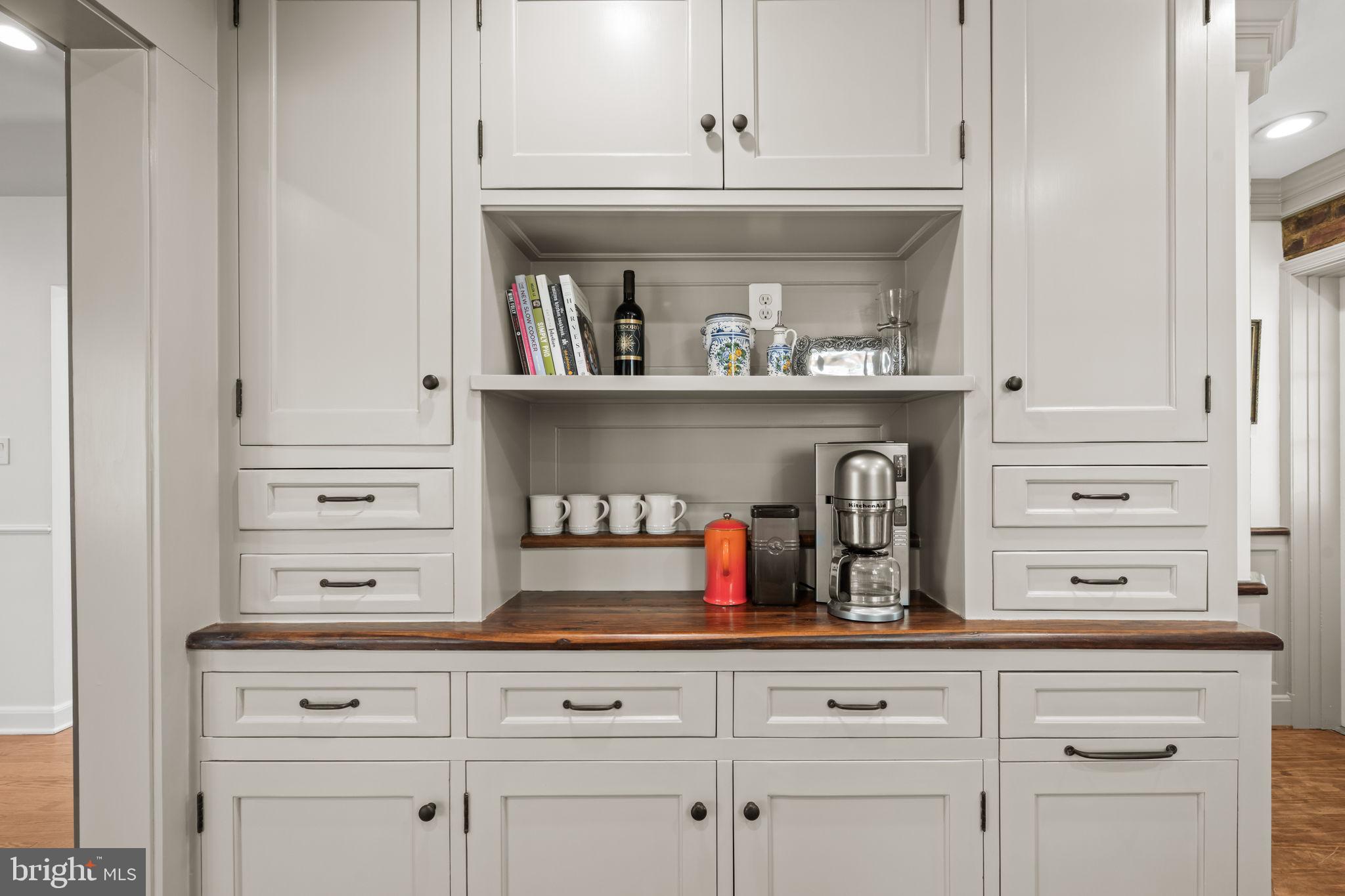 3814 Hillcrest Lane Annandale, VA 22003 - Photo 14 of 48 a kitchen with white cabinets and a wooden floor