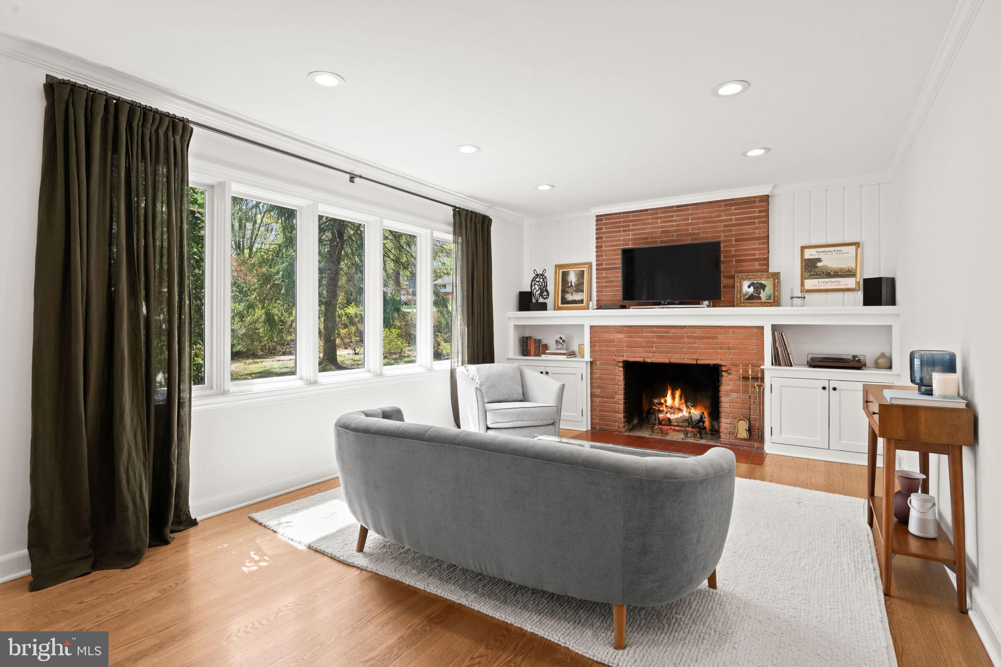 3814 Hillcrest Lane Annandale, VA 22003 - Photo 8 of 48 a living room with furniture a flat screen tv and a fireplace