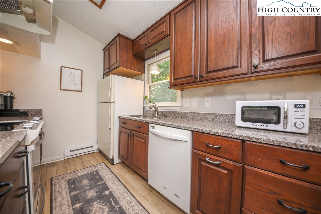 2171 Junaluska Road Boone, NC 28607 - Photo 4 of 46 a kitchen with granite countertop cabinets stainless steel appliances and a sink