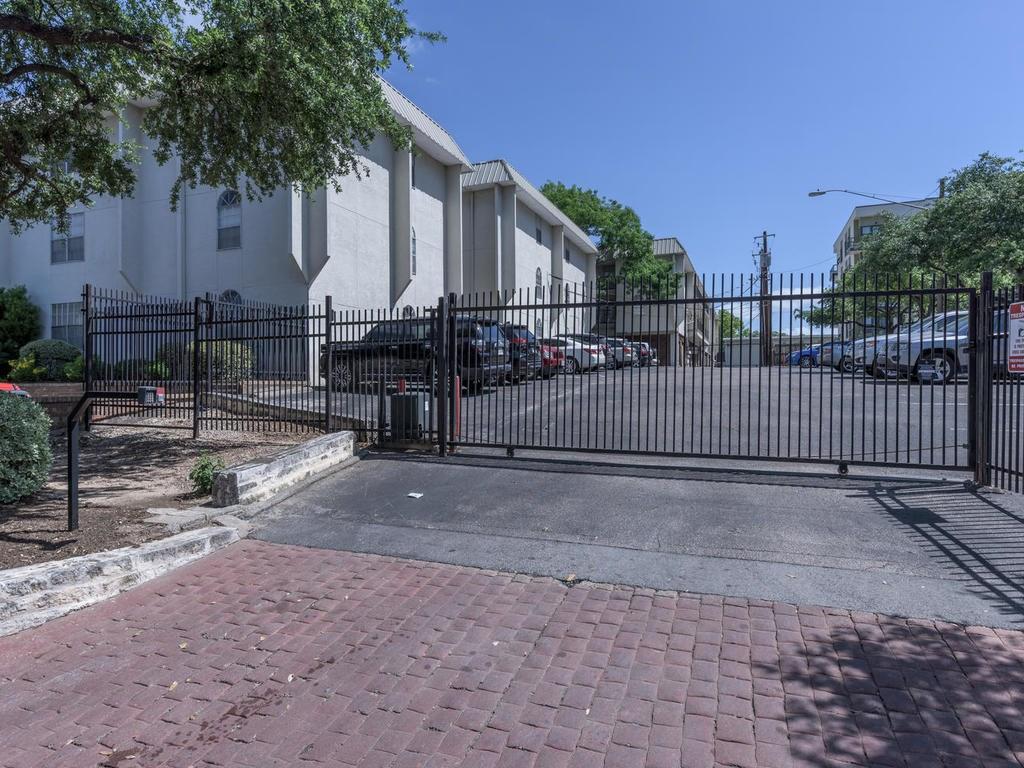 910 Duncan Lane, Unit 2 Austin, TX 78705 - Photo 8 of 11 Secure parking solutions behind a robust gated entry, ensuring privacy and peace of mind.