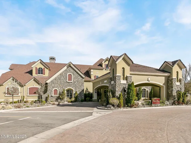 an aerial view of a house with a yard and balcony