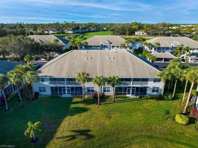 an aerial view of a house with a yard and lake view