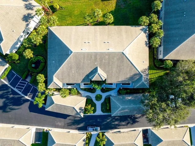 an aerial view of a house with a yard and sitting area