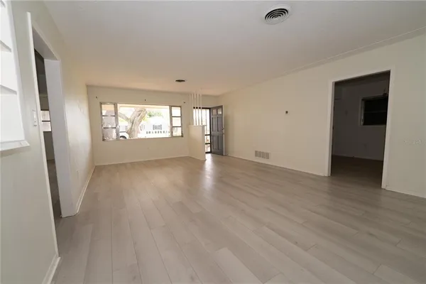 wooden floor in an empty room with a window