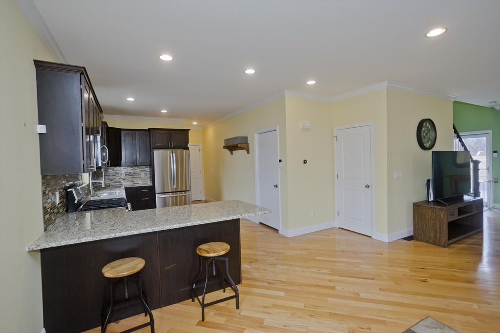 48 Mountain Avenue West Springfield, MA 01089 - Photo 13 of 39 a kitchen with stainless steel appliances granite countertop a sink a stove a refrigerator and a microwave