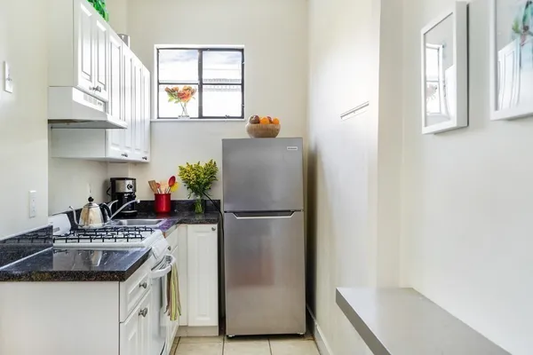 a white refrigerator freezer sitting inside of a kitchen