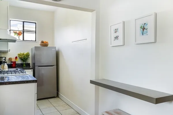 a white refrigerator freezer sitting inside of a kitchen