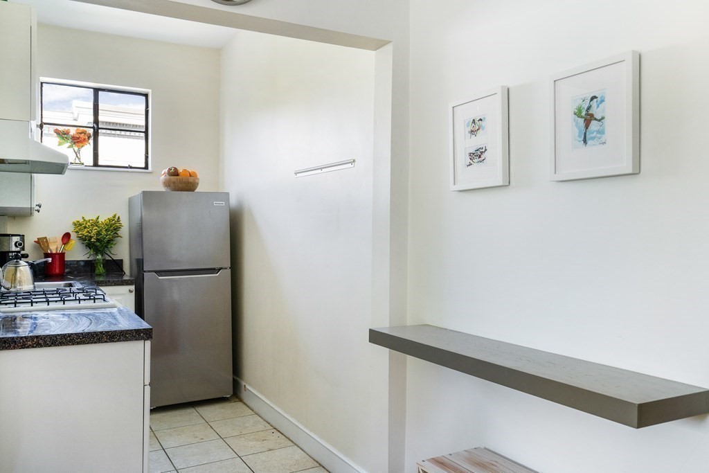 15 Ellery Street, Unit 11 Cambridge, MA 02138 - Photo 12 of 22 a white refrigerator freezer sitting inside of a kitchen