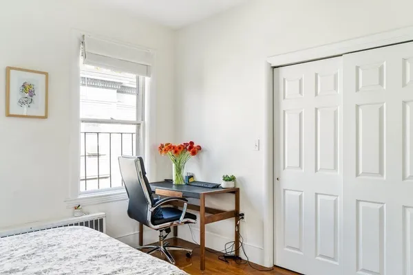 a workspace room with furniture and window