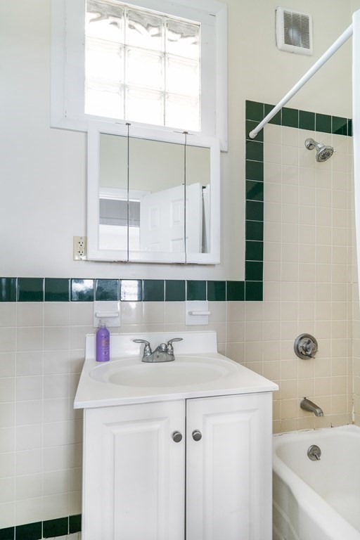 15 Ellery Street, Unit 11 Cambridge, MA 02138 - Photo 18 of 22 a bathroom with a sink and a mirror