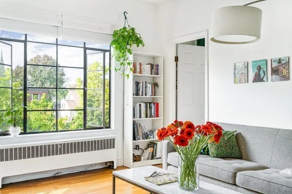 a living room with furniture and flowers