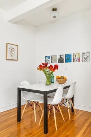 a view of a dining room with furniture and wooden floor