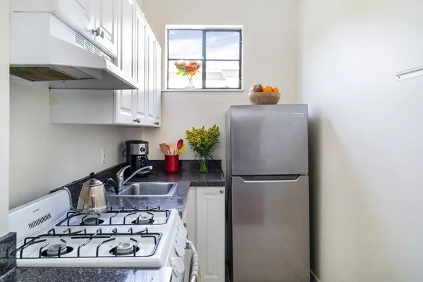 a kitchen with a refrigerator and a stove
