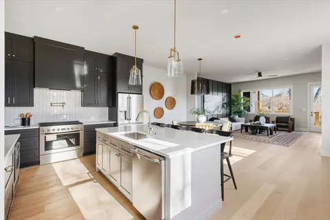 a large kitchen with lots of counter space and sink