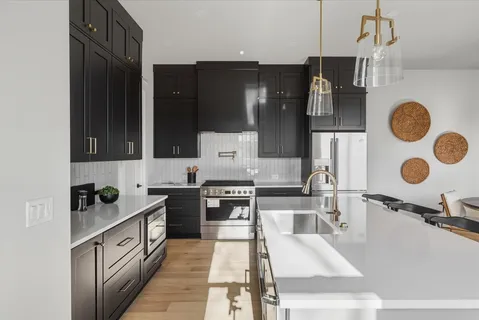 a kitchen with granite countertop a stove and a refrigerator