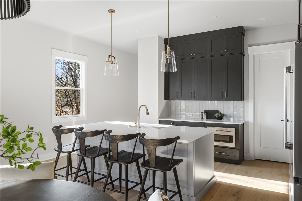 1902 3rd Avenue North, Unit B Nashville, TN 37208 - Photo 9 of 47 a kitchen with a table and chairs in it