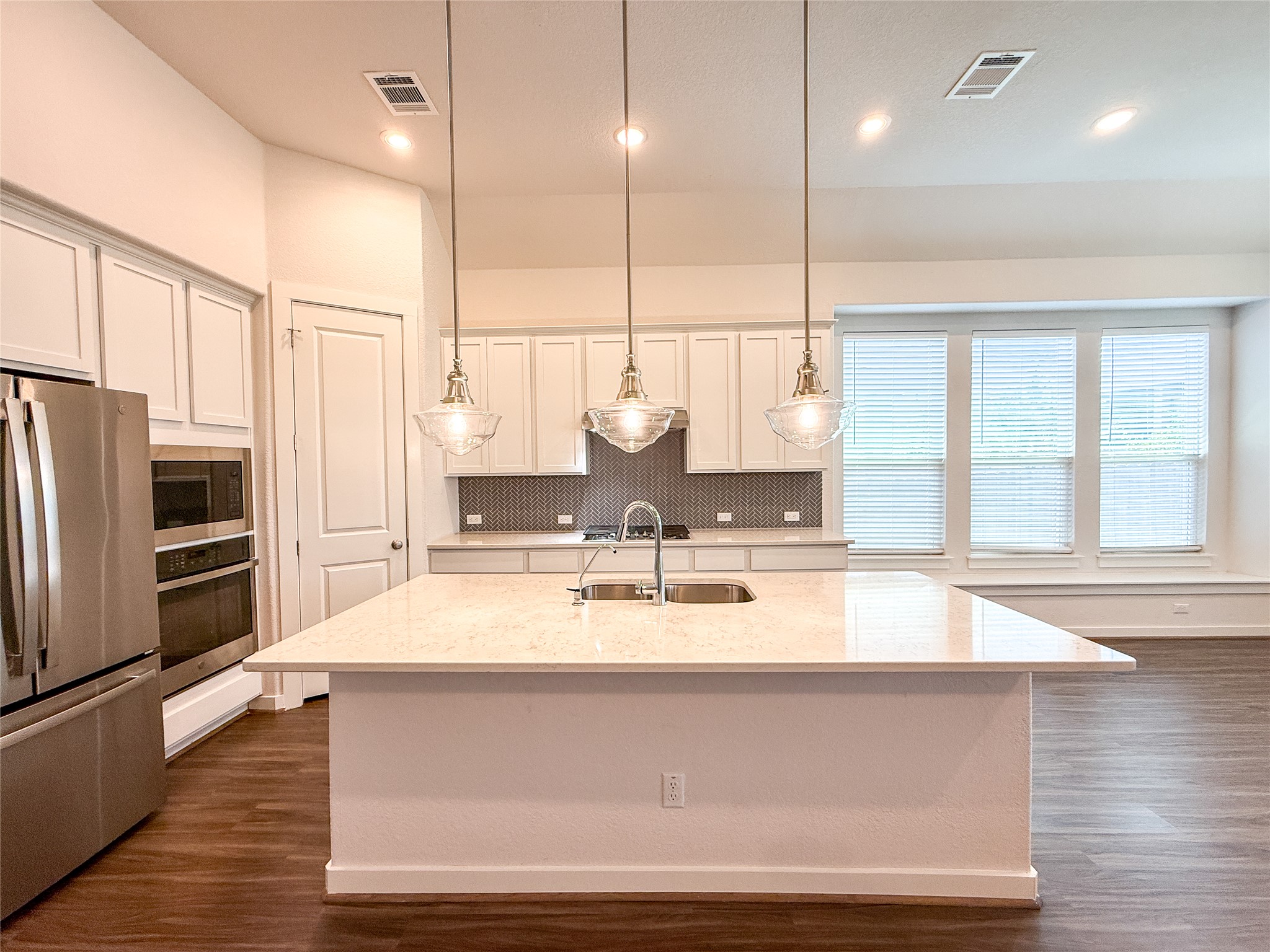 249 Heartleaf Road San Marcos, TX 78666 - Photo 9 of 38 A luminous kitchen island anchors this inviting space, perfect for culinary endeavors and gatherings.