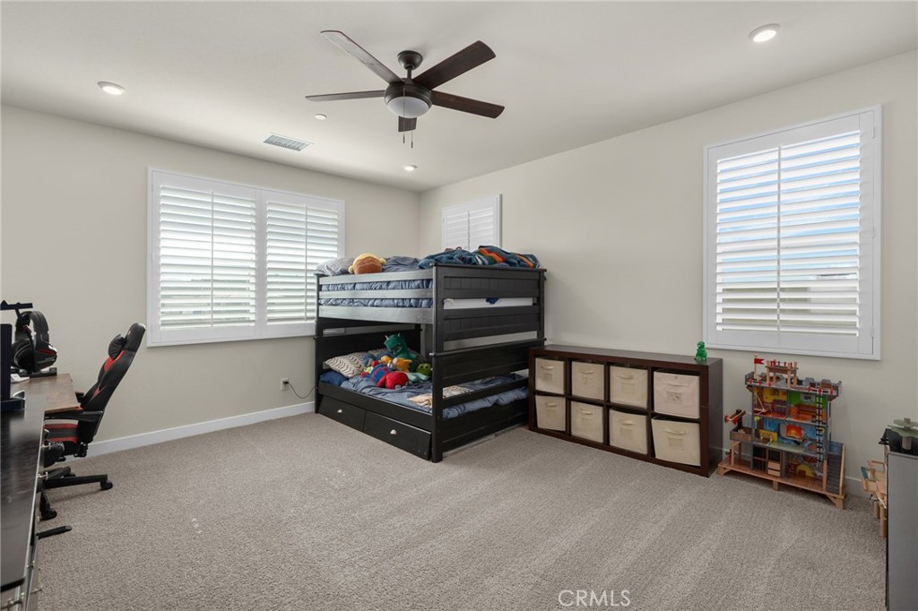 16155 New Canaan Court Riverside, CA 92504 - Photo 21 of 26 a bedroom with furniture and a window