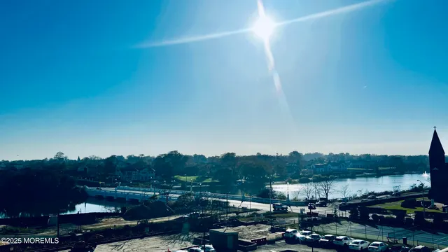 a living room with furniture and floor to ceiling windows
