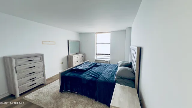 a living room with furniture and a dresser