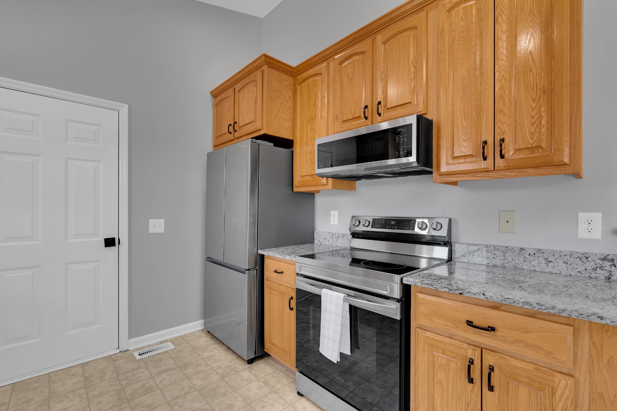 3896 Lynchburg Road Winchester, TN 37398 - Photo 17 of 57 a kitchen with stainless steel appliances granite countertop a stove microwave and refrigerator