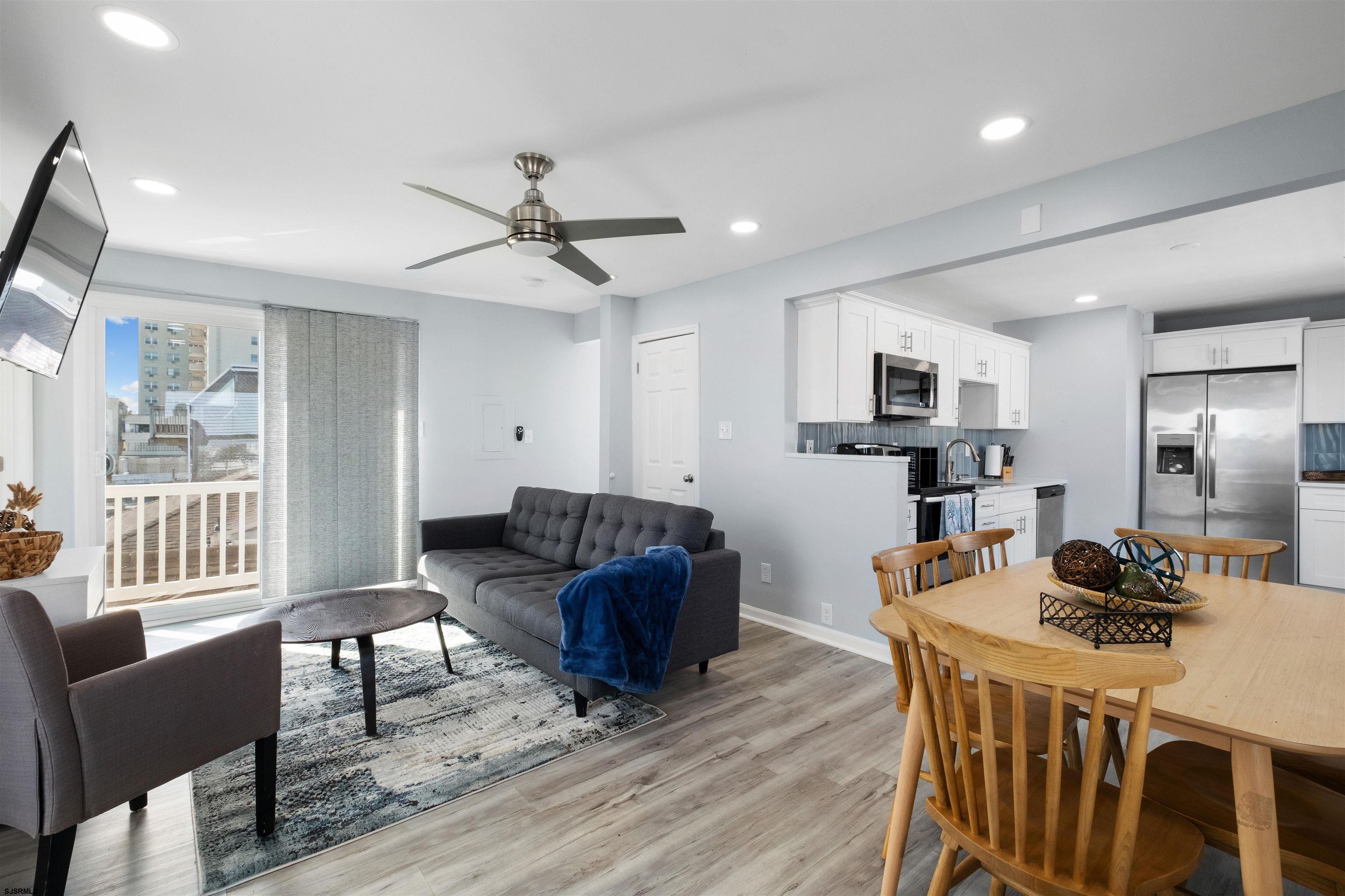 69 North Harrisburg Avenue, Unit 4 Atlantic City, NJ 08401 - Photo 11 of 25 a living room with furniture a flat screen tv and kitchen view