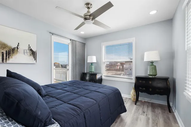 a bedroom with a large bed and a night stand