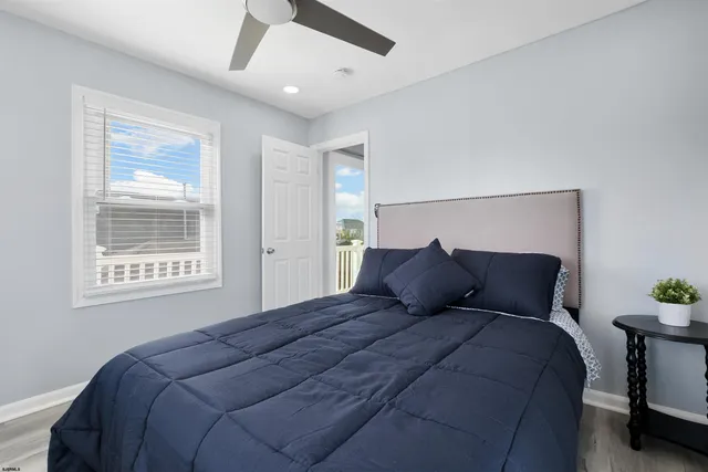 a large bed sitting in a bedroom next to a window