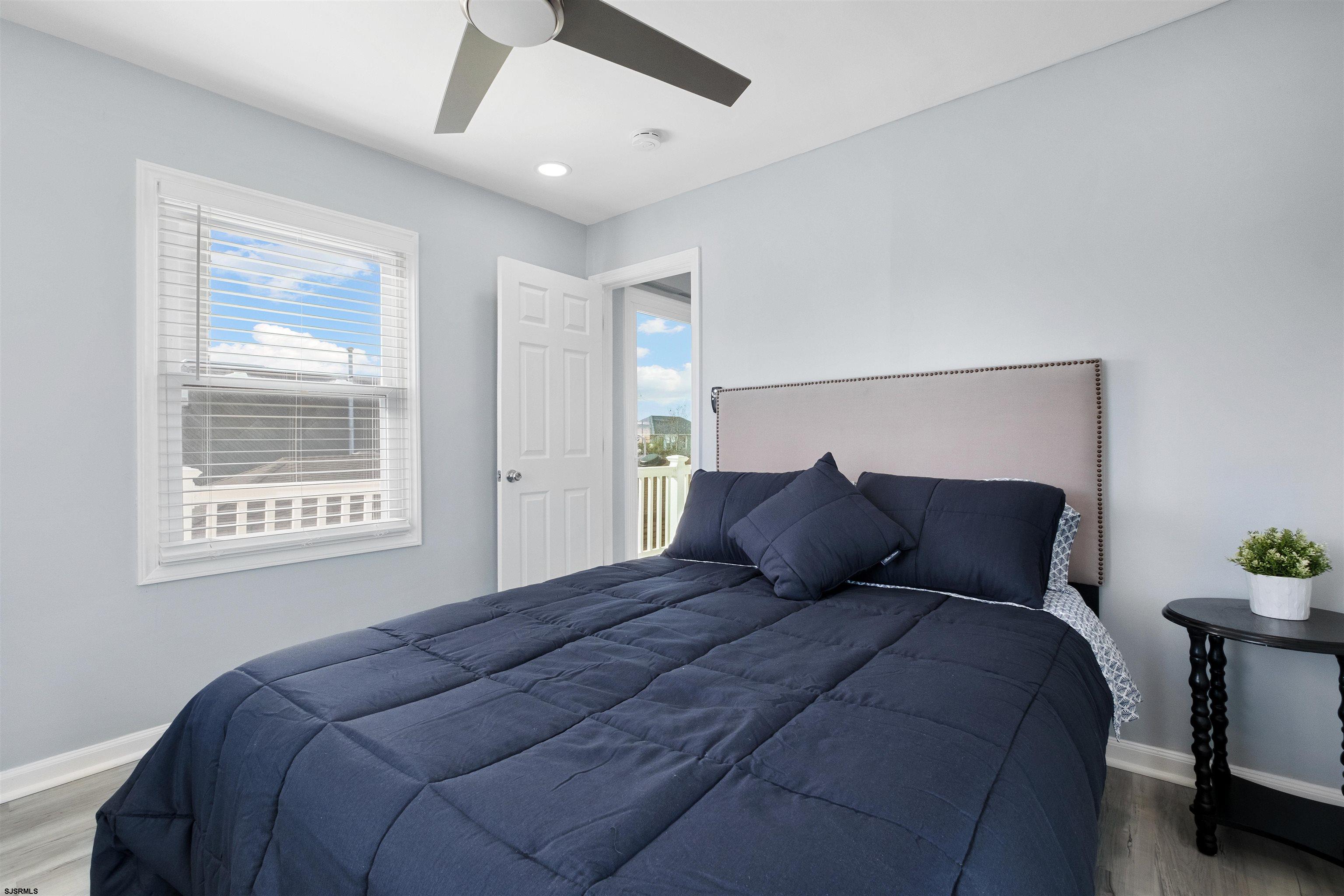 69 North Harrisburg Avenue, Unit 4 Atlantic City, NJ 08401 - Photo 21 of 25 a bedroom with a large bed and a potted plant