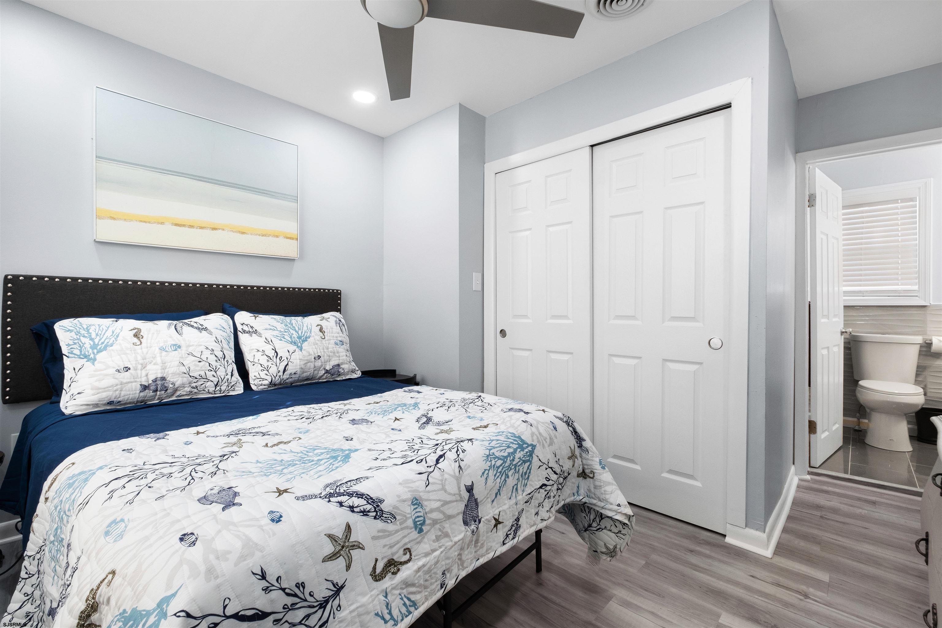 69 North Harrisburg Avenue, Unit 4 Atlantic City, NJ 08401 - Photo 22 of 25 a bedroom with a large bed and a night stand