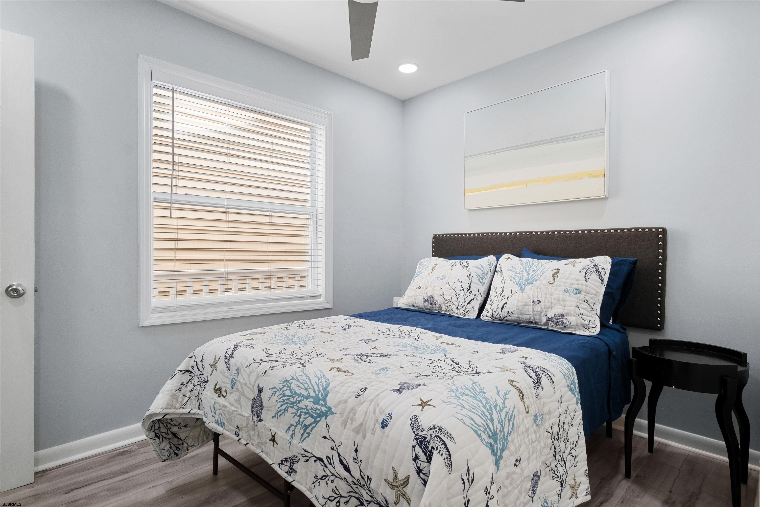 69 North Harrisburg Avenue, Unit 4 Atlantic City, NJ 08401 - Photo 23 of 25 a large bed sitting in a bedroom next to a window