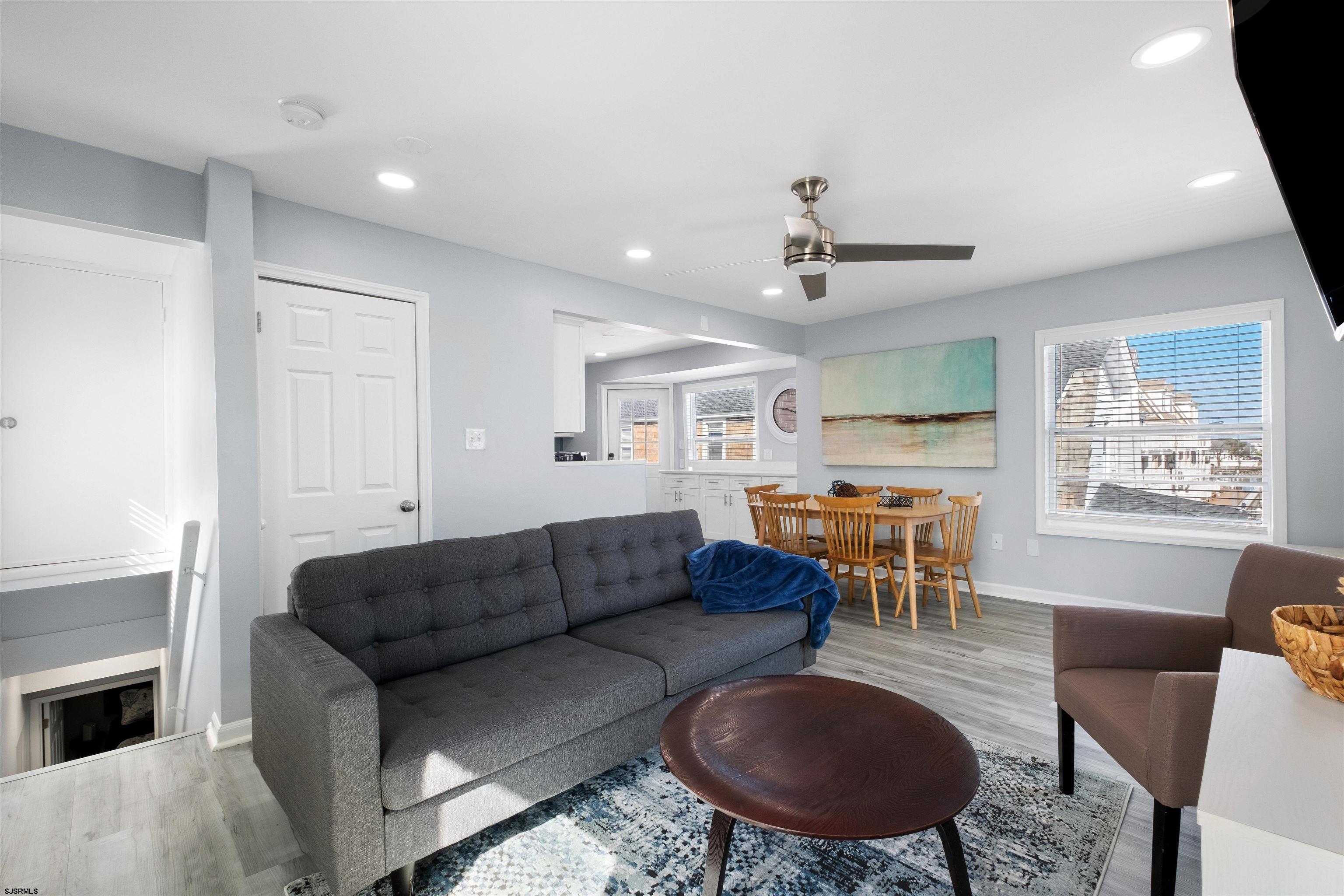 69 North Harrisburg Avenue, Unit 4 Atlantic City, NJ 08401 - Photo 9 of 25 a living room with furniture a dining table and kitchen view