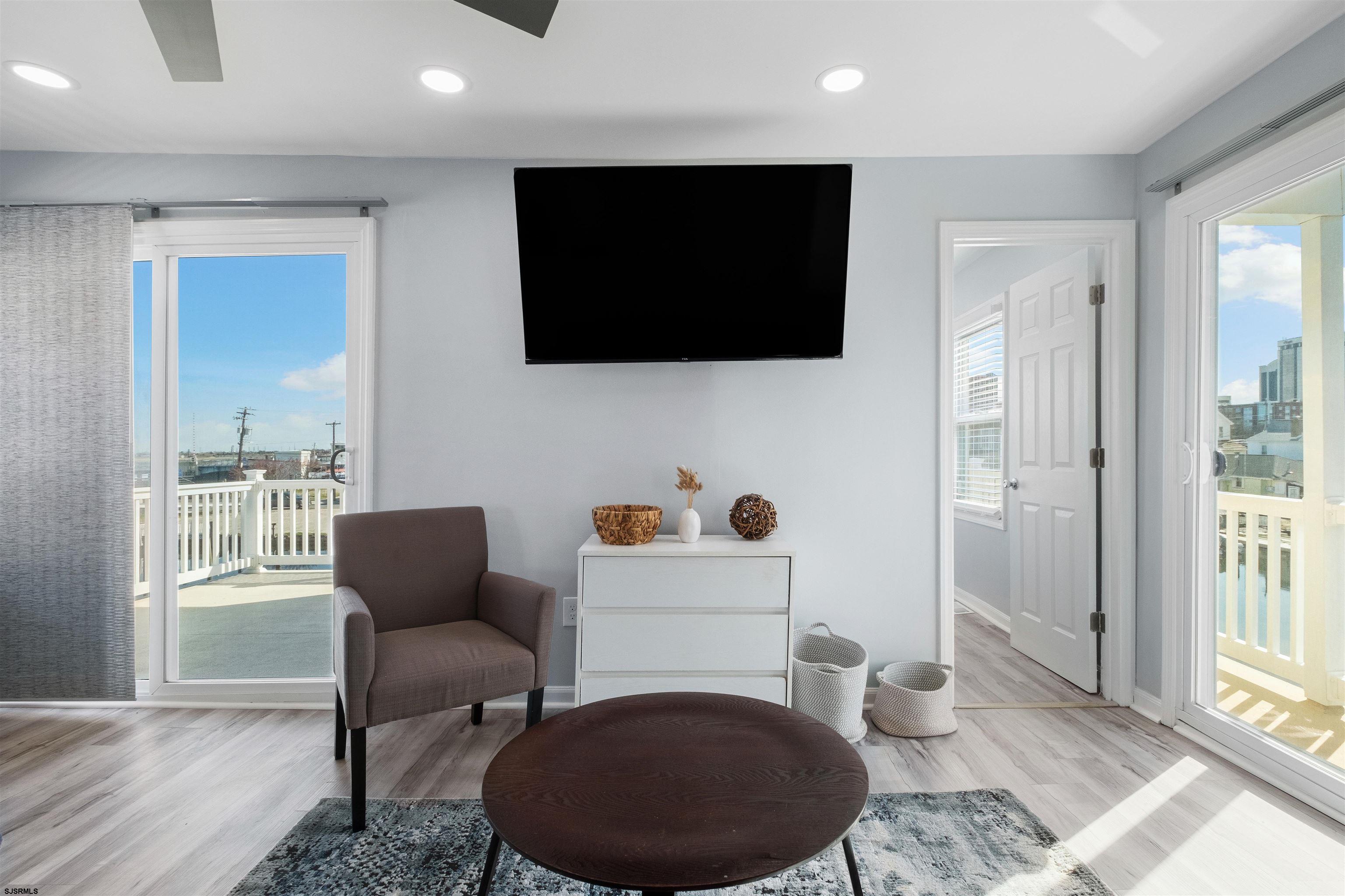 69 North Harrisburg Avenue, Unit 4 Atlantic City, NJ 08401 - Photo 10 of 25 a living room with furniture and a flat screen tv