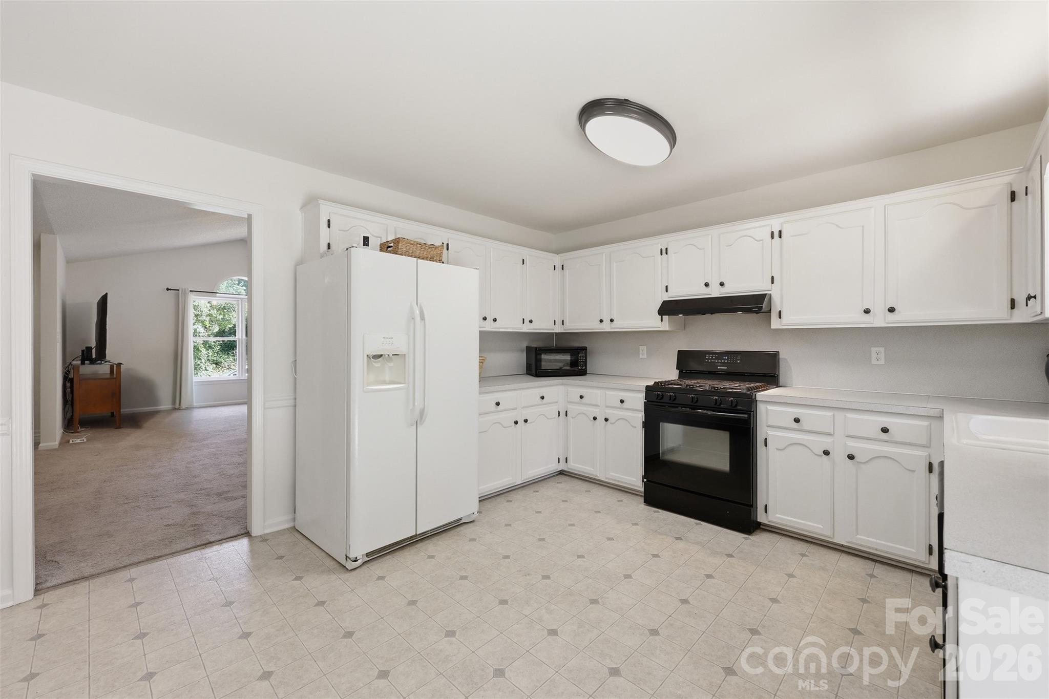 913 Pleasant Ridge Road Fort Mill, SC 29715 - Photo 10 of 40 a kitchen with white cabinets and white appliances