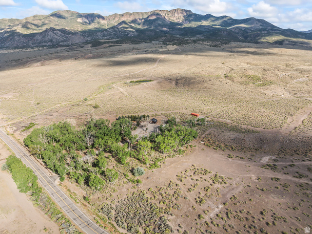 460 Omni Point Road Central Valley, UT 84754 - Photo 88 of 101 Expansive rural property featuring a paved road frontage, mature trees, open land, and mountain backdrop