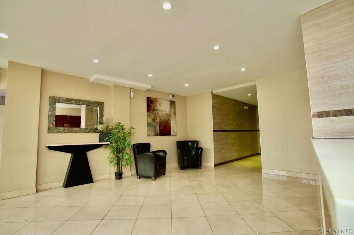 99-60 63rd Road, Unit 7Q Queens, NY 11374 - Photo 2 of 12 a lobby with furniture and rug