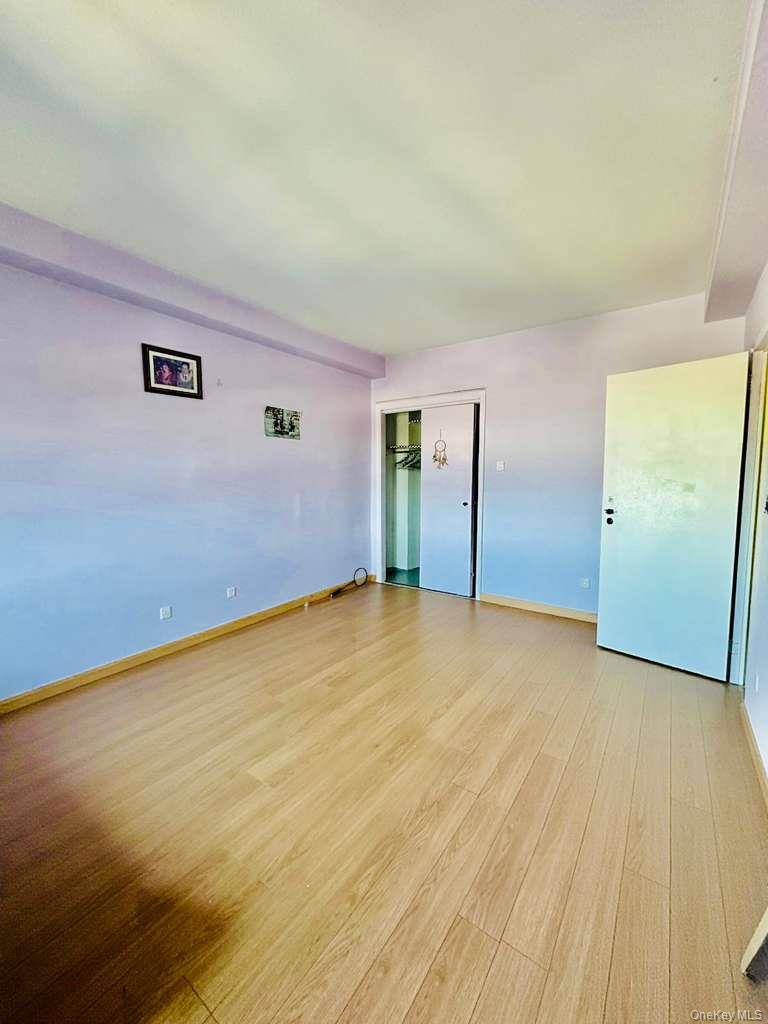 99-60 63rd Road, Unit 7Q Queens, NY 11374 - Photo 10 of 12 a view of empty room with wooden floor