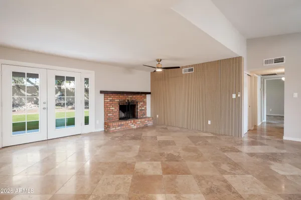 a view of empty room with a fireplace