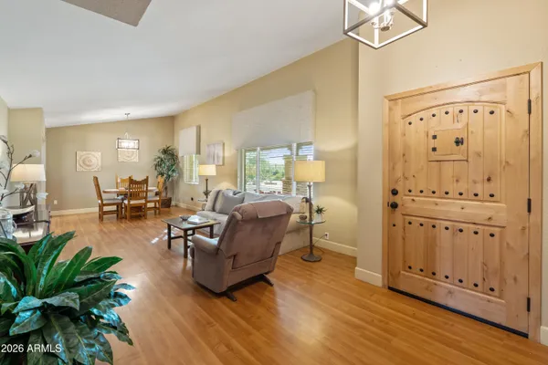 a view of a workspace with furniture and a fan